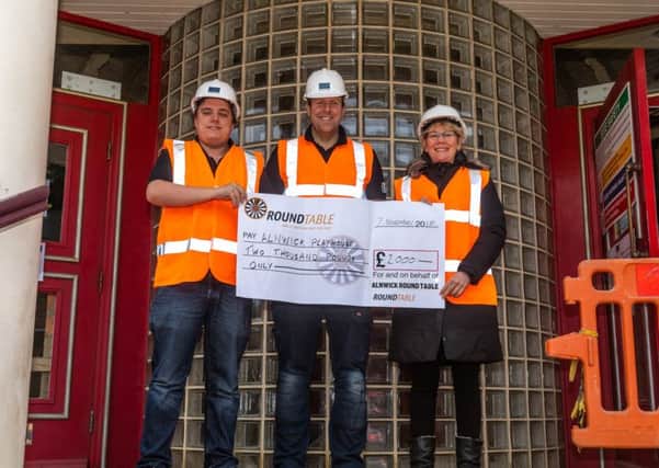 Playhouse technical manager Andy Hunt, left, and theatre manager Jo Potts, with Adam Lambert, centre, chairman of Alnwick Round Table handing over a cheque for £2,000. Picture by Andrew Mounsey.