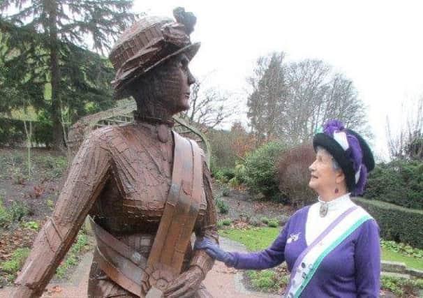 Penni Blythe with a sculpture of suffragette Emily Wilding Davison in Morpeth.