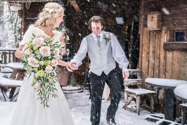 Snow joke! Jemma and Steve have a laugh in the blizzard at ther wedding in the Treehouse at The Alnwick Garden. Picture by Sean Elliott Photography