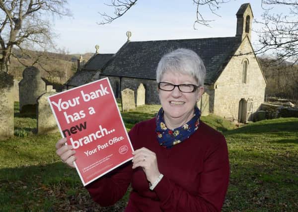 Sub postmistress Bessie Rogerson outside St Mary's Church in Holystone. Picture by Jane Coltman