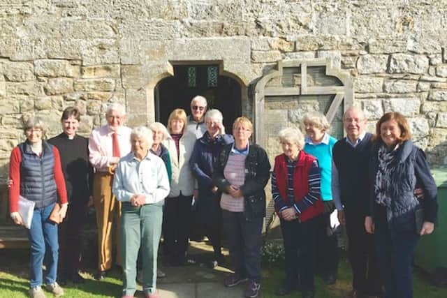A crowd gathers for the opening of the Post Office outreach service at St Mary's Church, Holystone.