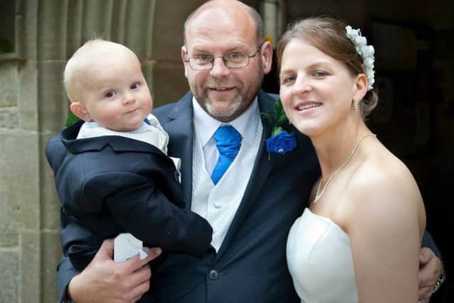 Jimmy and Sam Ryder-Somerville with their son Charlie on their wedding day, which was also his Christening.