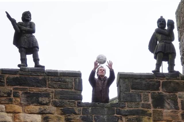 The Duke of Northumberland throws the ball from the Barbican at Alnwick Castle. Picture by Jane Coltman
