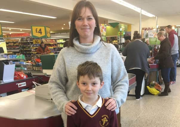 Louise Hodgson, chairman of the PTA, with son Archie at the bag pack in Morrisons.