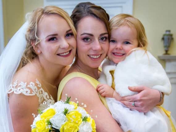 Bride Kat Sterling, left, with her star bridesmaid Emma Reed, centre,