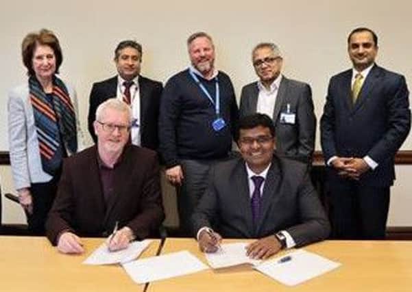 Representatives of both organisations sign a memorandum of understanding.