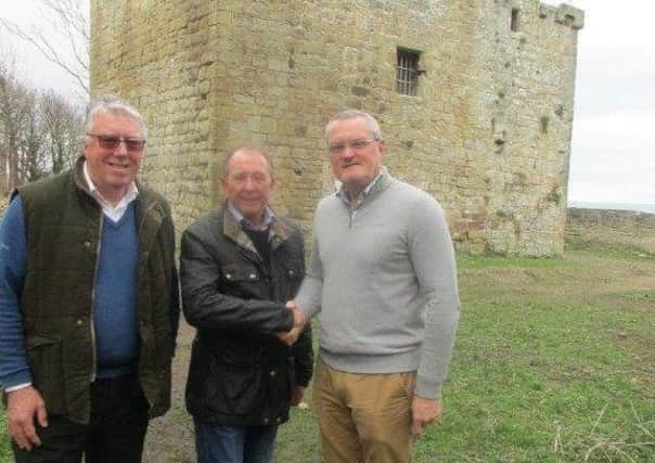 A handshake between Michael Wright, centre, and Stephen Griffiths seals the deal by Parkdean Resorts to grant a lease on Cresswell Pele Tower. Looking on is David Lodge, chief executive of Greater Morpeth Development Trust.