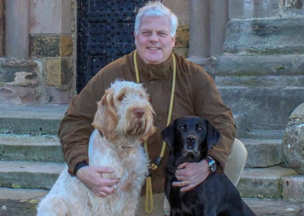 Francis Watson-Armstrong with his dogs.