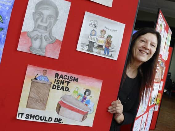 Education manager Sue Schofield with some of the entries in the Show Racism The Red Card English Schools Competition at the Linskill Centre in North Shields last week. Picture by Jane Coltman