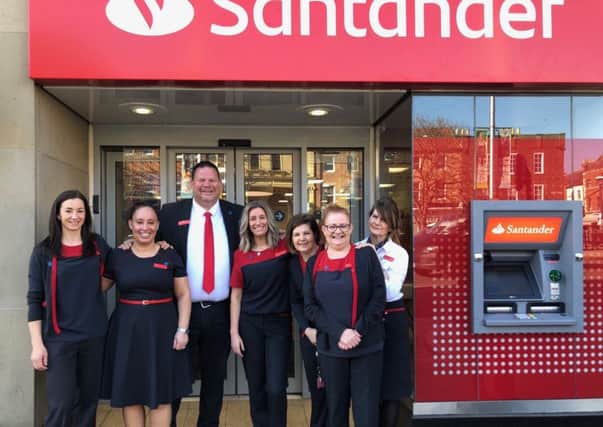 Manager Stephen Harrison and other staff at the entrance to the newly designed and refurbished Santander branch in Morpeth.