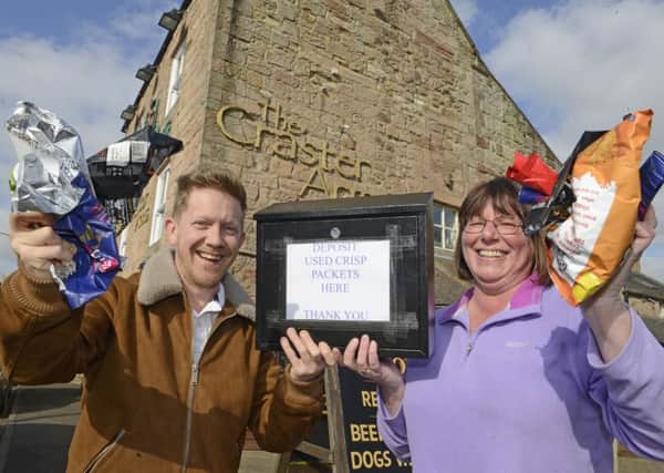 Amanda Crowley, a Coast Care volunteer from Swinhoe, and  Michael Dawson, landlord of the Craster Arms in Beadnell, who are asking people to recycle empty crisp packets. Picture by Jane Coltman