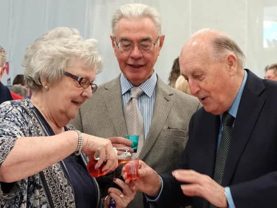 Just a little! Joan Moses offers Sir John a sample of her plum brandy.Picture by Jane Coltman