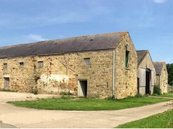 A picture of the two barns to be converted and the other to be demolished, which was submitted with the application.