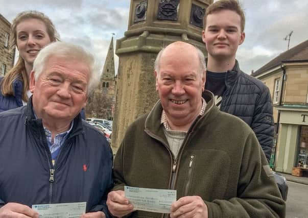 Jeff Watson and Fred Calvert with the cheques presented to them by Will Jones and Milly Davis. Picture by Brian Young