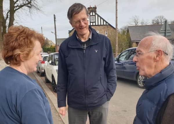 John Appleby speaks with residents in Longframlington during his campaigning.