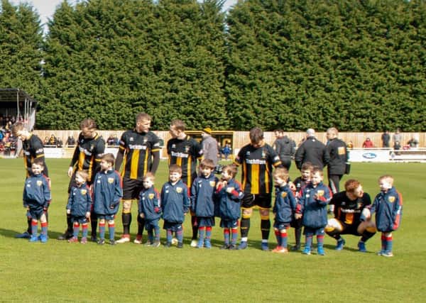 The Longhoughton Lions mascots line-up on the pitch with Morpeth Town.
