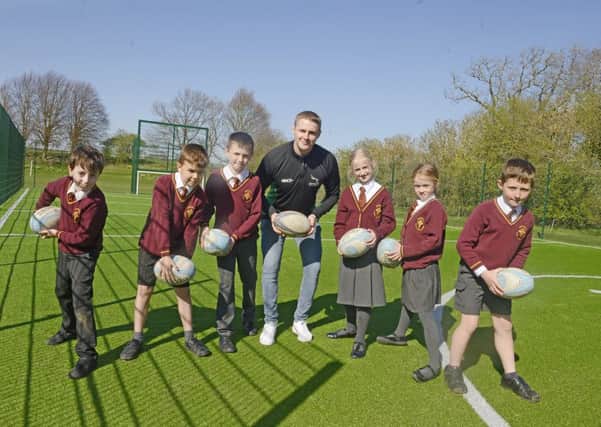 Falcons rugby player Tom Penny, with Whittingham Primary School pupils in their new MUGA. Picture by Jane Coltman