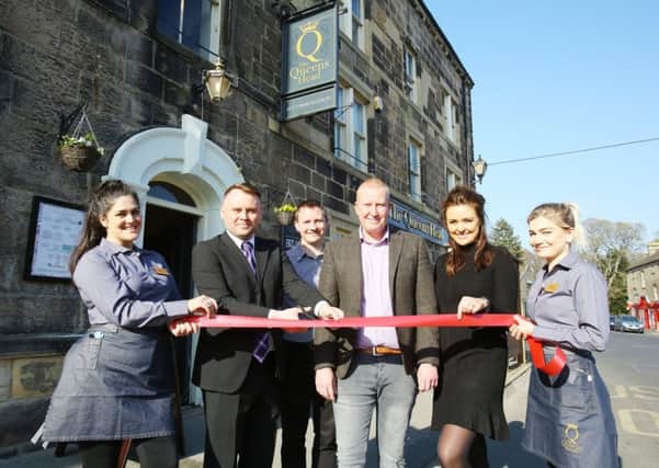 Coun Steven Bridgett, second left, cuts the ribbon with, left to right, Jenny Hale, Punch development manager Simon Lynch, publicans Craig and Nicola Fortune and Anna Coe.