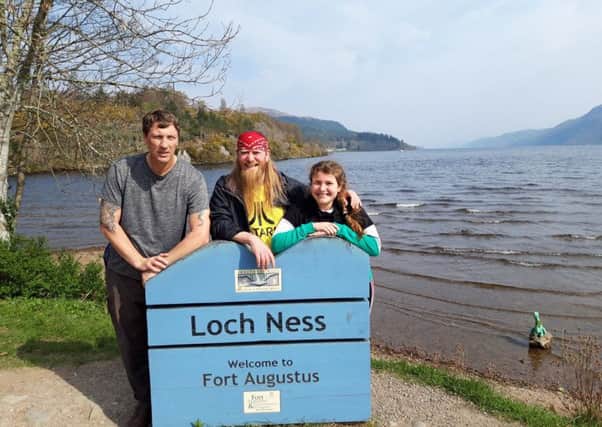 Shaun Watts, left, with Derek and Ellie Allan at Loch Ness.