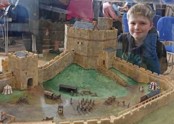 Edmund Turner, 10,  admires the model of Harbottle Castle on show at the launch of OOT in Rothbury. Picture by Jane Coltman