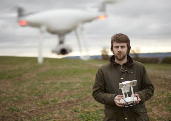 Jack Wrangham flying a drone.