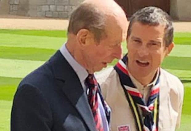 The Duke of Kent and Chief Scout Bear Grylls in the quadrangle at Windsor Castle.