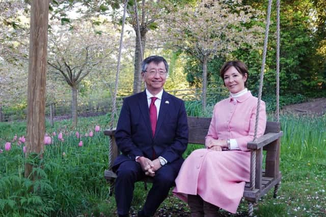 The Japanese Ambassador and the Duchess of Northumberland on one of the swings in the Cherry Orchard at The Alnwick Garden.