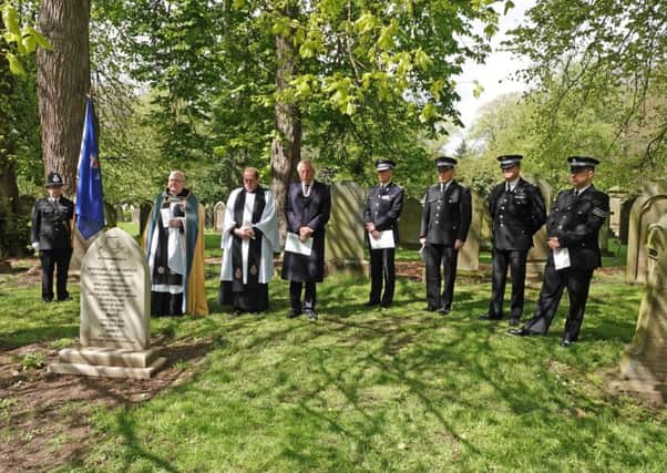 A service is held at the grave of police sergeant John Hately, who died in 1875 after being struck by a missile during a riot in Alnwick. Picture by Jane Coltman