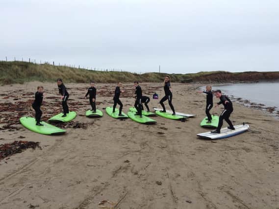 Pupils at Seahouses Primary School get to work on their surfing skills before taking to the water.