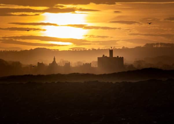 Sunset over Warkworth Castle. Picture by Ivor Rackham.