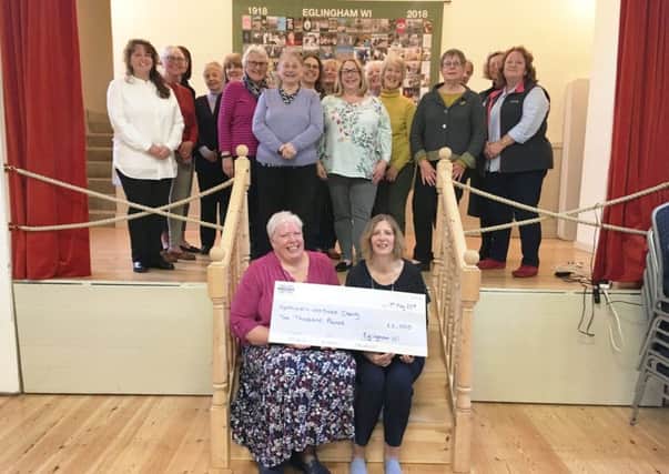 Left, Brenda Robertson, president of Eglingham WI, presents the cheque to nurse Catherine Johnstone, right, with Eglingham WI members.