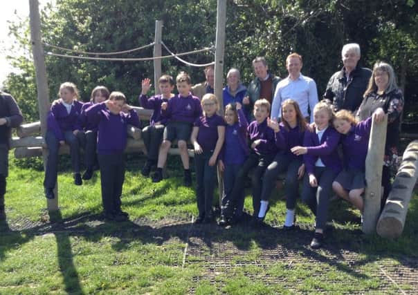 Pupils from Swansfield Park Primary School try out the equipment at the new Bull Field Community Orchard play area in Alnwick.