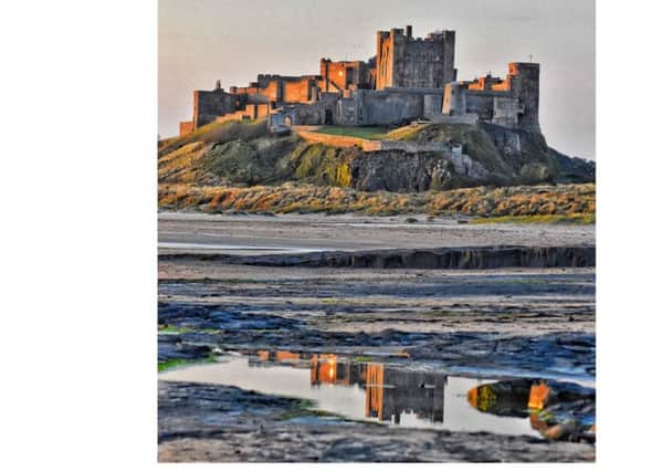 FIRST: Bamburgh Castle reflected in a pool on the wet sand by Darren Chapman. 825 Facebook likes