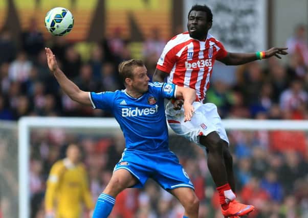 Stoke City's Mame Biram Diouf (right) and Sunderland's Lee Cattermole