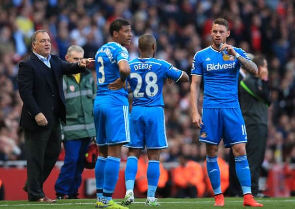 Sunderland manager Dick Advocaat (left) gives advice for Sunderland's Jermaine Defoe (centre right) and Connor Wickham (right).