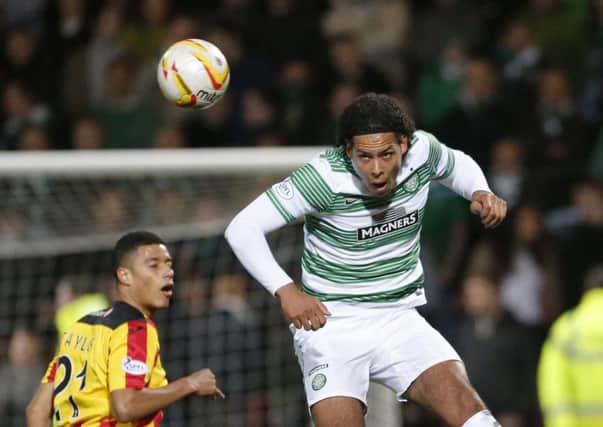 Celtic's Virgil van Dijk beats Partick's Thistle's Lyle Taylor to the ball during the Scottish Premier League match at Firhill Stadium, Glasgow. PRESS ASSOCIATION Photo. Picture date: Wednesday March 26, 2014. See PA story SOCCER Partick. Photo credit should read: Danny Lawson/PA Wire. RESTRICTIONS: Editorial use only