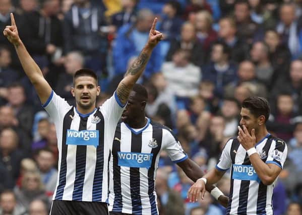 Newcastle United's Aleksandar Mitrovic celebrates, with Ayoze Perez in the background.