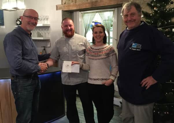 Jonny Bird and his wife Julie, owners of Sea and Soil, presenting the cheque to Dr Paul Morrison and Dr Keith Clarkson.