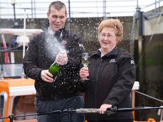 Margaret Kelley celebrating her win with her son Richard at RNLI Amble Lifeboat Station.