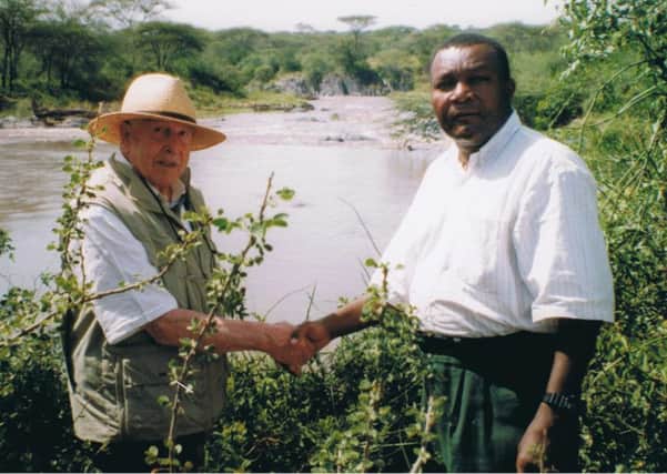 Lance meets a local resident during his safari in Tanzania.