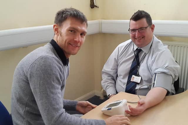 Stephen having his blood pressure checked, pictured with David Turnbull, health improvement officer, Public Health, Northumberland County Council.