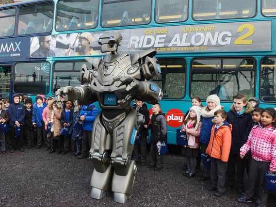 TITAN the robot helped launch the new Arriva X20 buses with children from St Aidan's RC School in Ashington. Picture by Jane Coltman