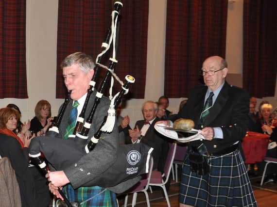 Piper Andy Spence and John Hall carry the haggis at Alnmouth's Burns Night Supper on Friday. Picture by Terry Collinson