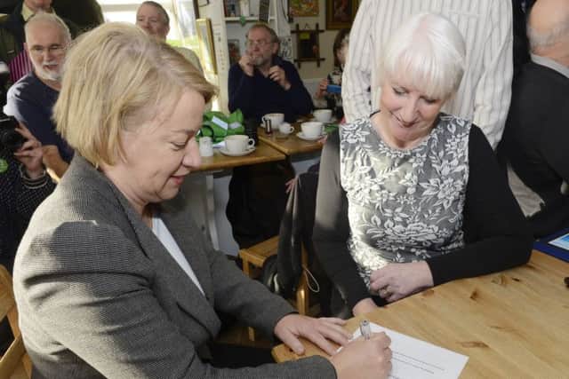 Natalie Bennett signs the petition with Lynne Tate, secretary of the Save Druridge campaign group. Picture by Jane Coltman