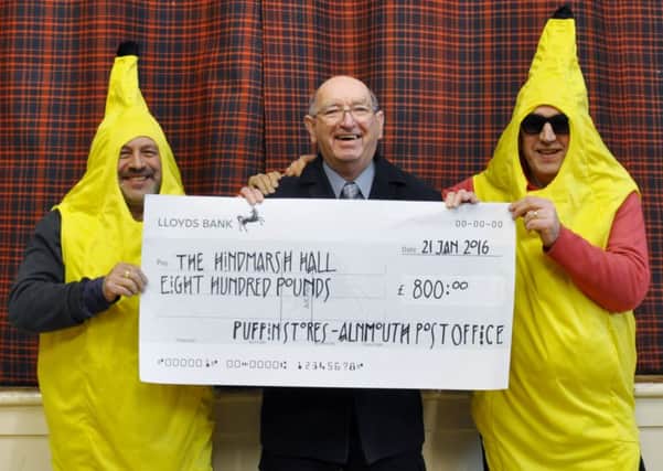 Puffin Stores owner Nick Mattlock and colleague Robin Winder presenting a cheque to John Hall, chairman of the Hindmarsh Hall Committee. Picture by Terry Collinson