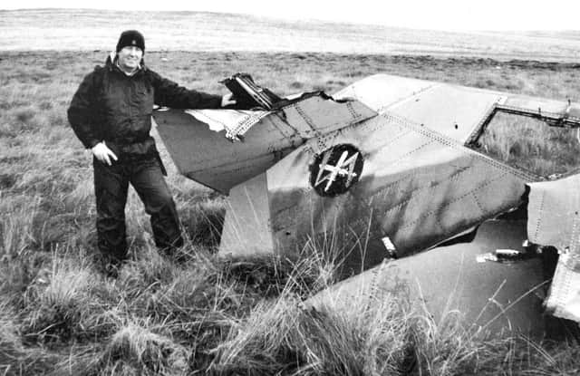 Author Chris Davies with the tail section of one of the crashed planes.
