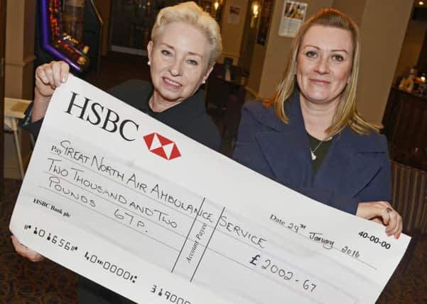 Joy Lloyd, right, presents Great North Air Ambulance Service representative Pat Ford with a cheque for Â£2,002.67  the proceeds from the event at Riverside Lodge in Morpeth. Picture by Jane Coltman.