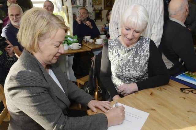 Green Party leader Natalie Bennett signs the petition with Lynne Tate, secretary of the Save Druridge campaign.