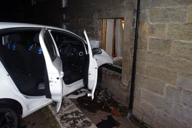 The car crashed into the house.