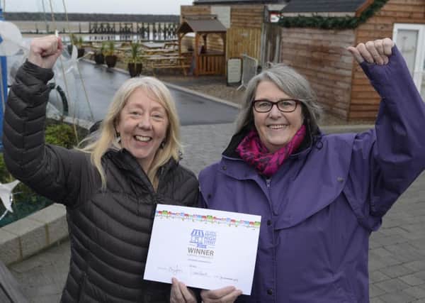 Amble Development Trust's Julia Aston and Ann Burke, of the town's business club, with the High Street Award. 
Picture by Jane Coltman